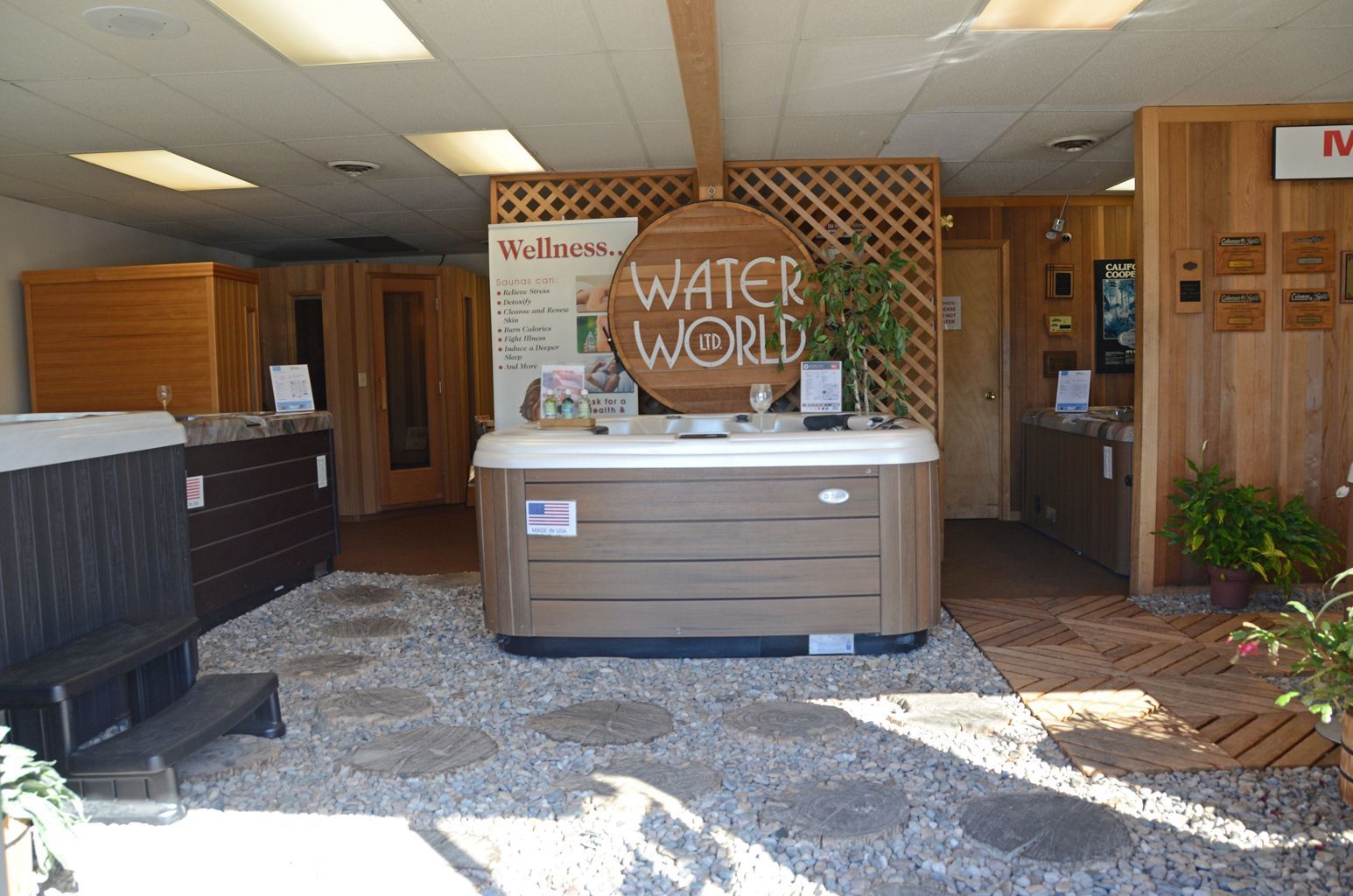 A hot tub is sitting in front of a sign that says water world
