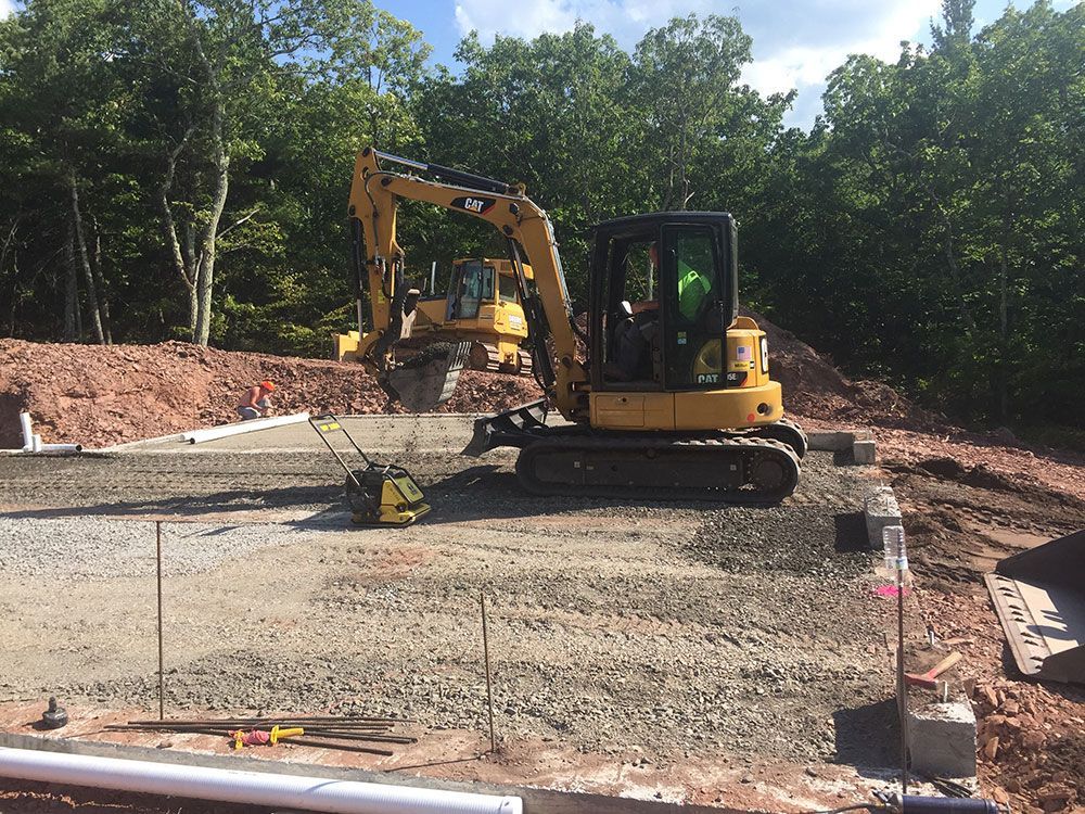 A man is driving a bulldozer on a construction site.