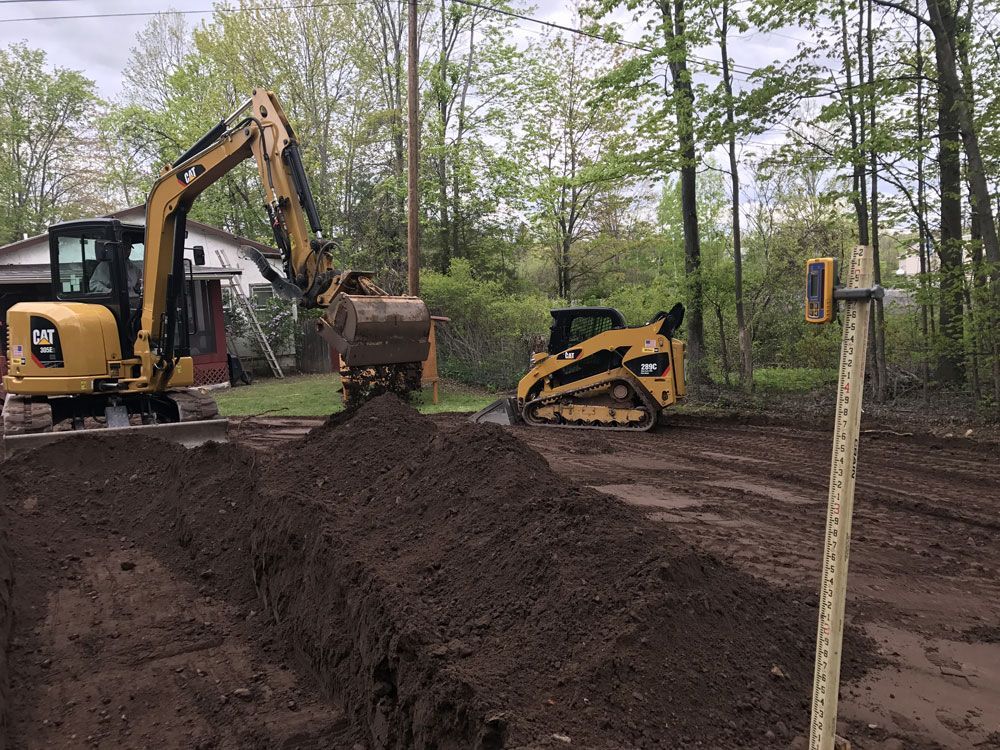 A bulldozer is digging a hole in a dirt field.