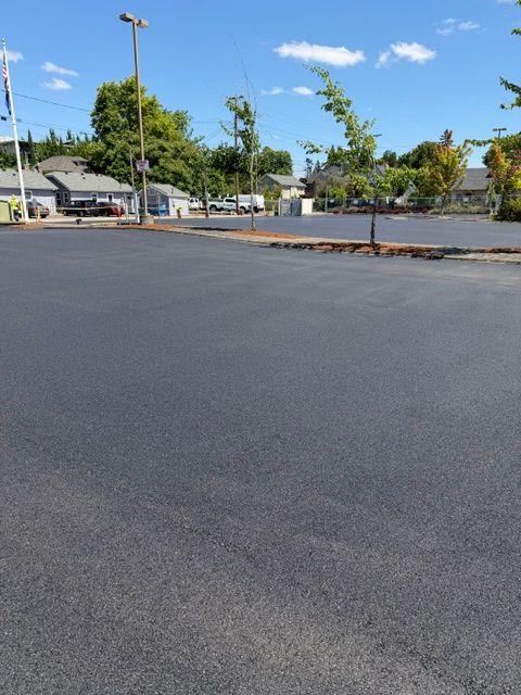 Empty parking lot with dark pavement