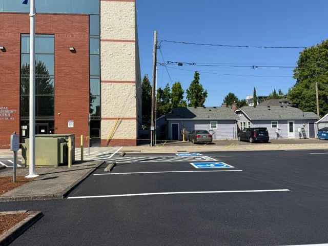 Empty accessible parking spaces beside a building on a sunny day