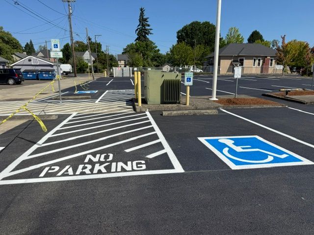 Accessible parking space beside a no parking zone in an empty parking lot