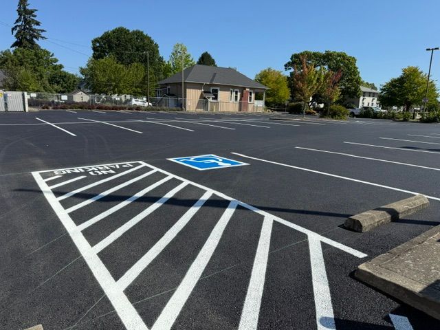 Empty parking lot with painted accessible parking space and blue wheelchair symbol