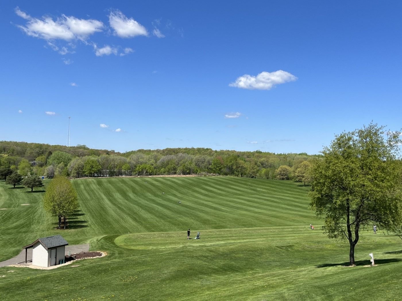 An aerial view of a golf course on a sunny day.