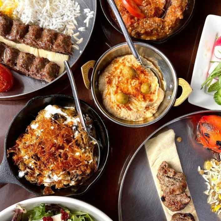 A table topped with plates of food and bowls of food