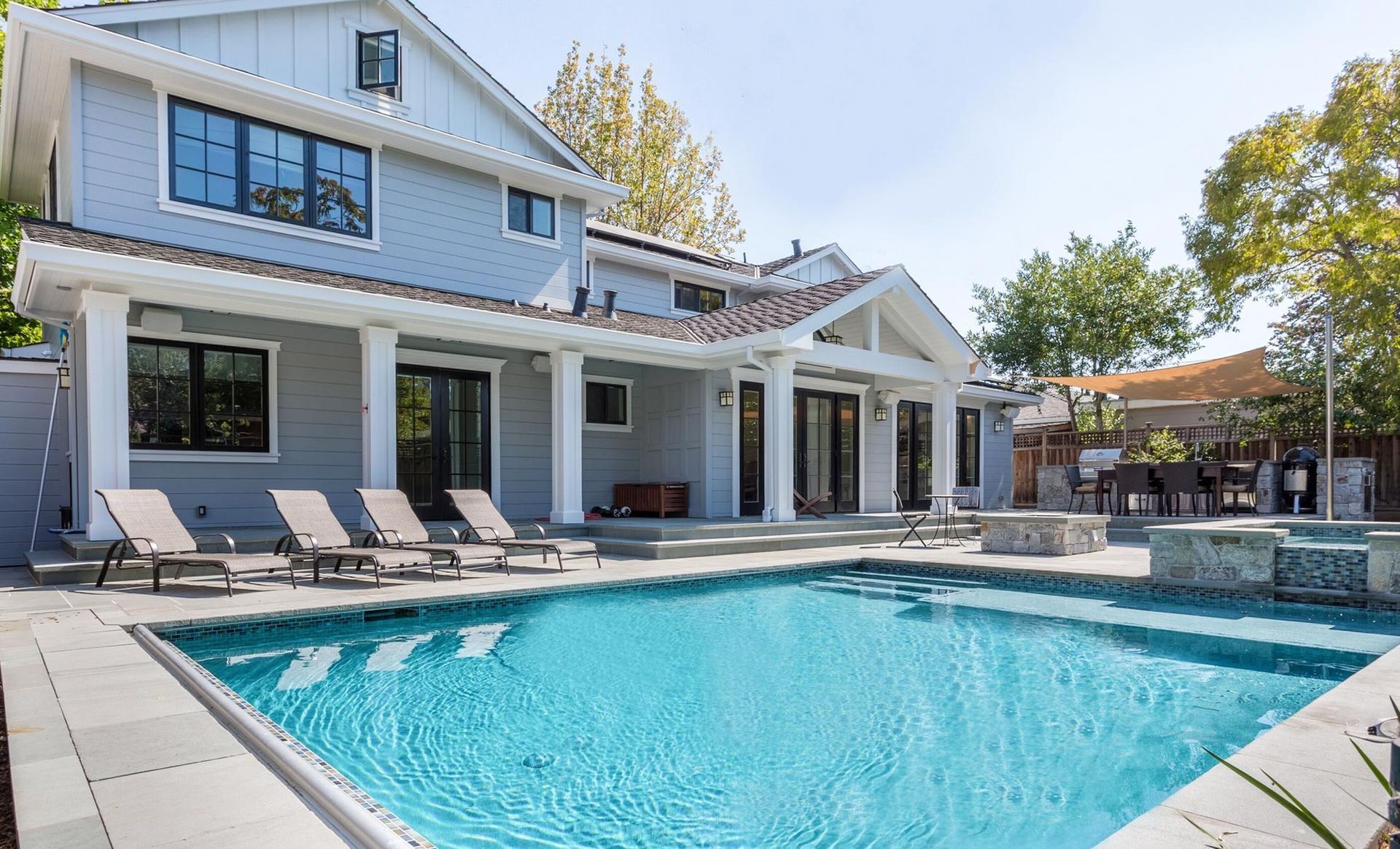 A large house with a large swimming pool in front of it.