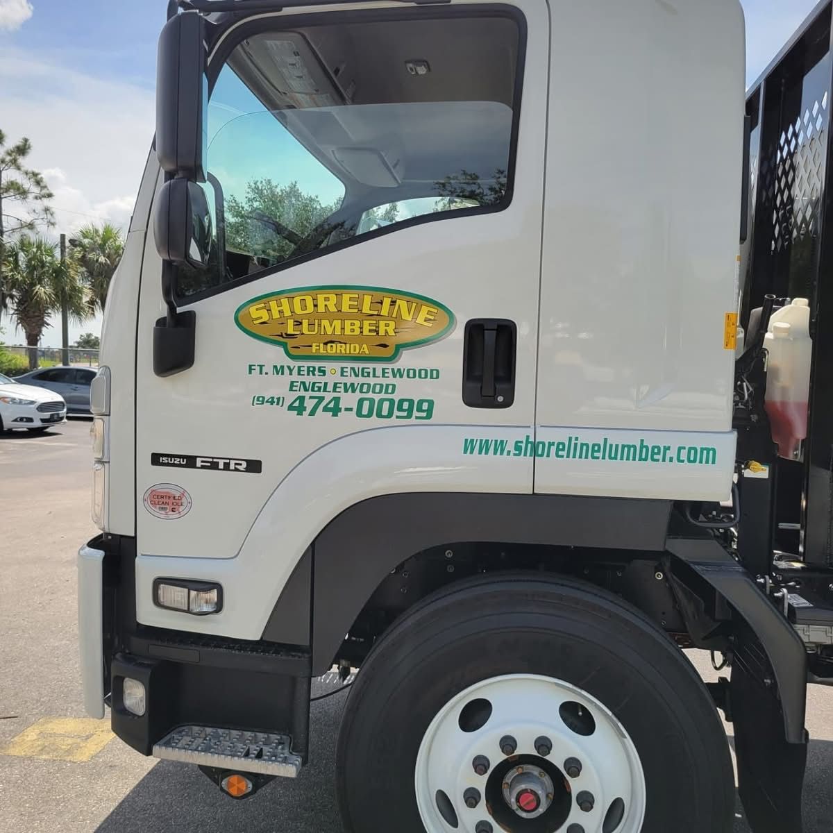A shoreline plumber truck is parked in a parking lot
