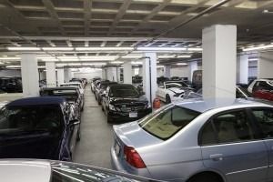 Indoor parking garage filled with parked cars and concrete columns