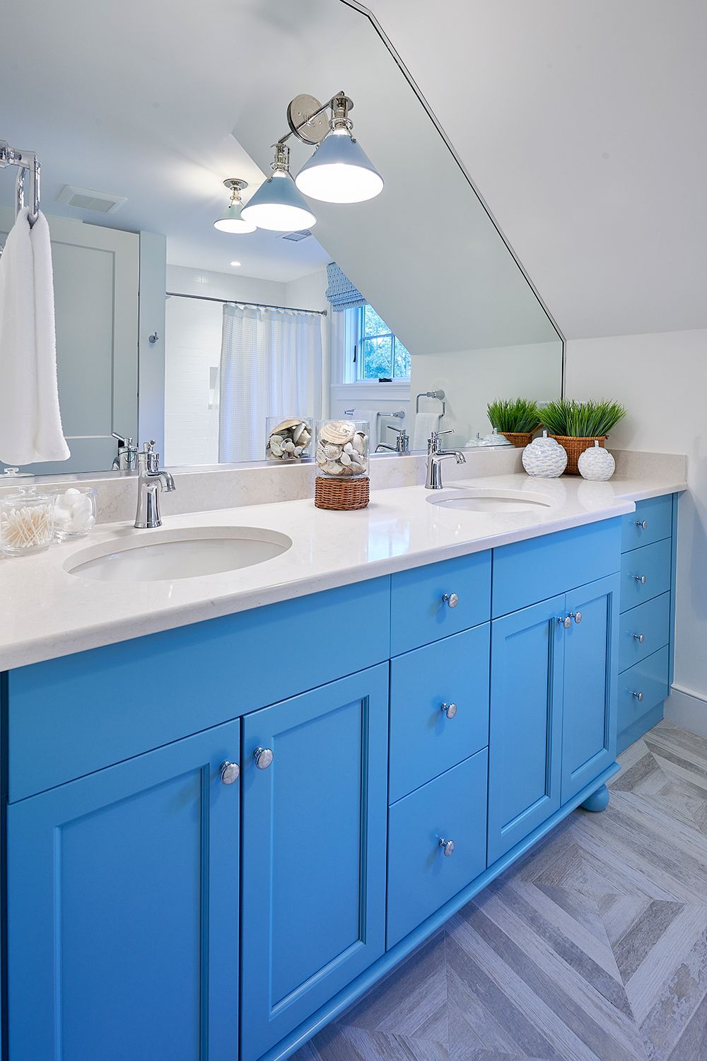 Cozy reading nook with striped armchair, wooden table, and blue pillow.