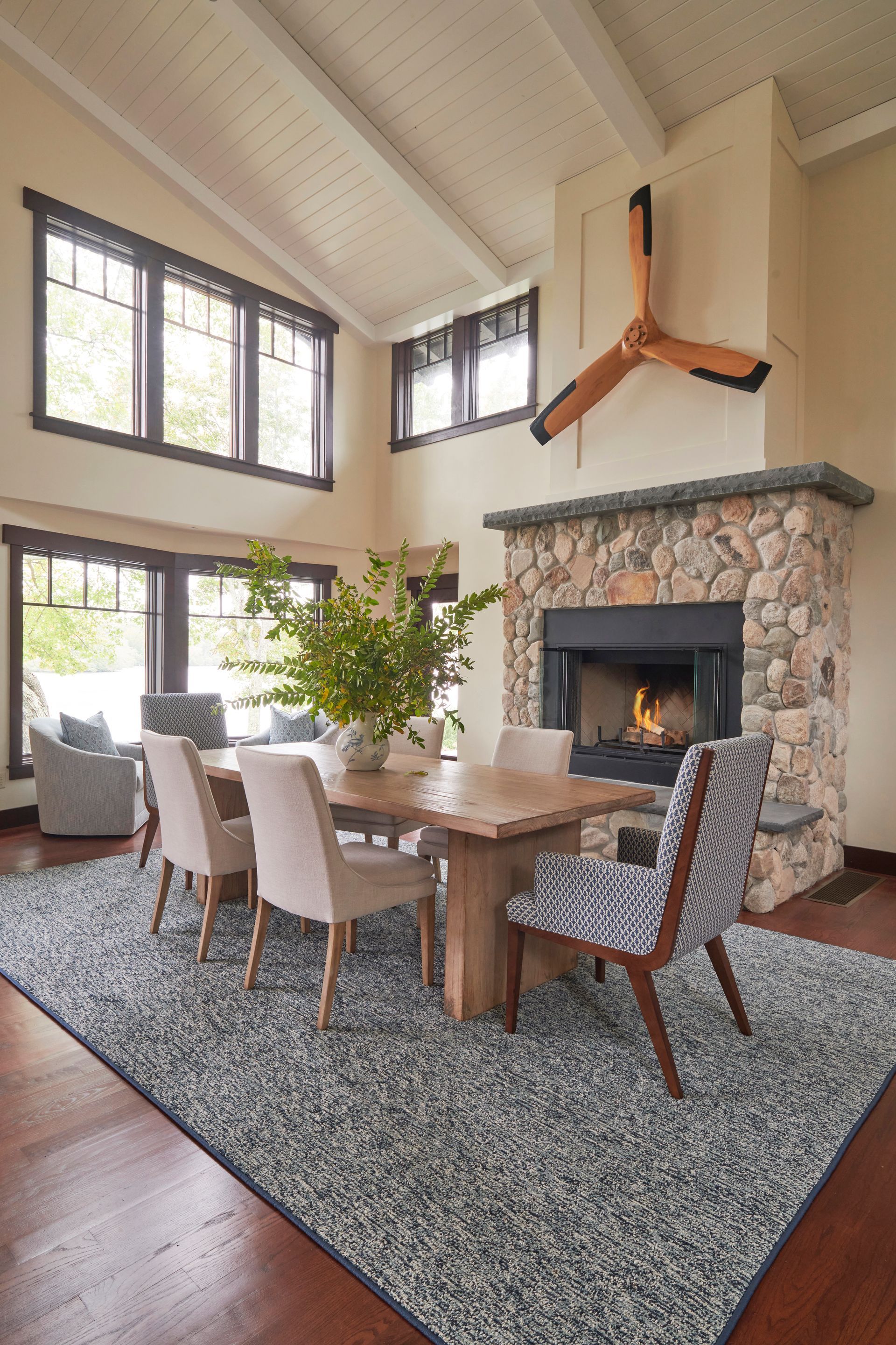 A dining room with a table and chairs and a fireplace