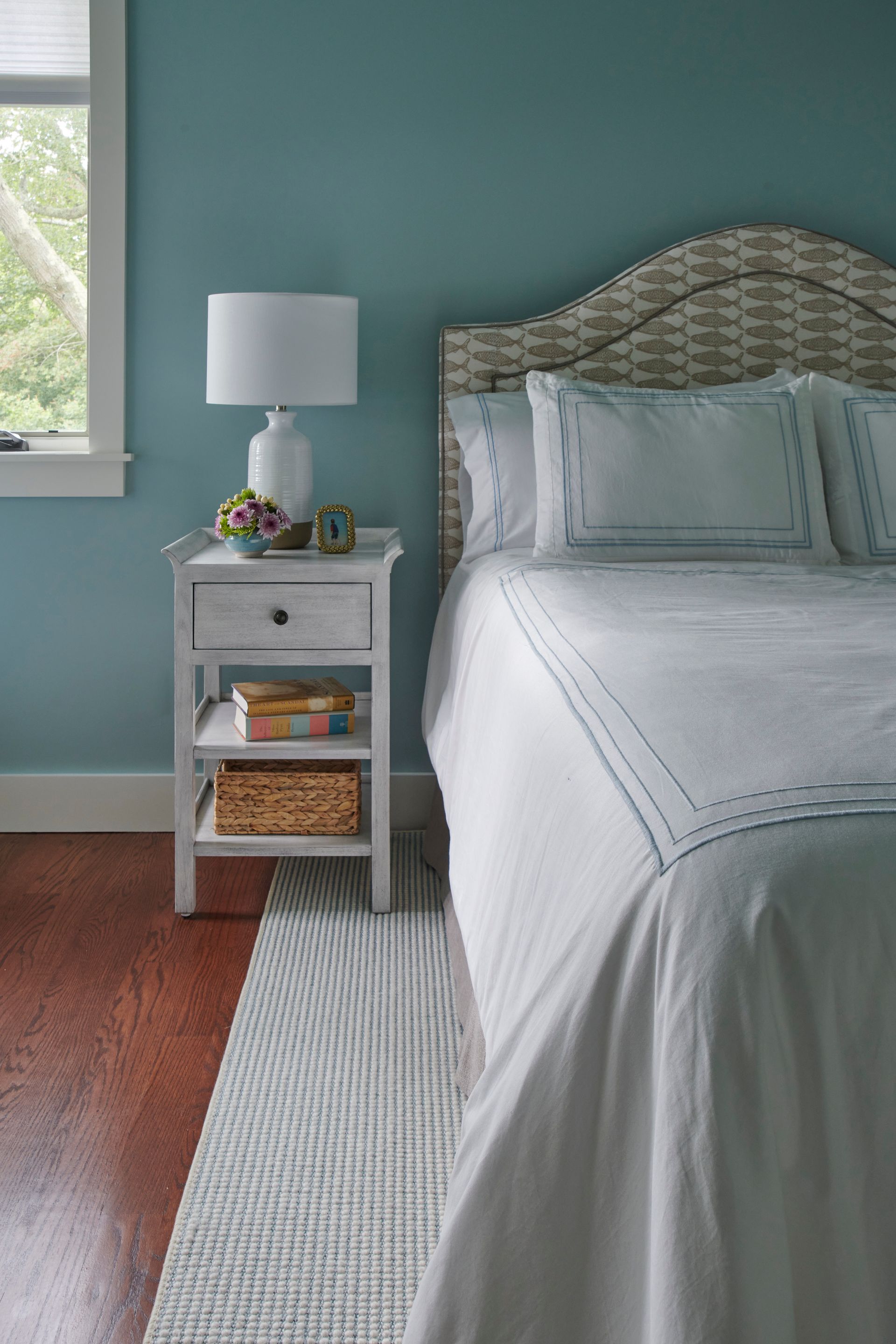 Bedroom with a bed, nightstand, lamp, and blue walls