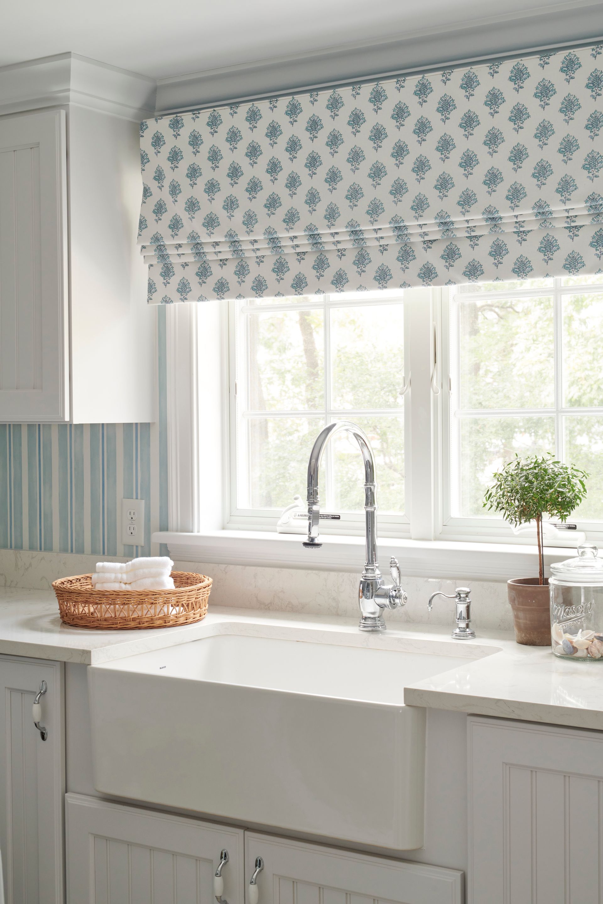 Kitchen with a sink, faucet, and window