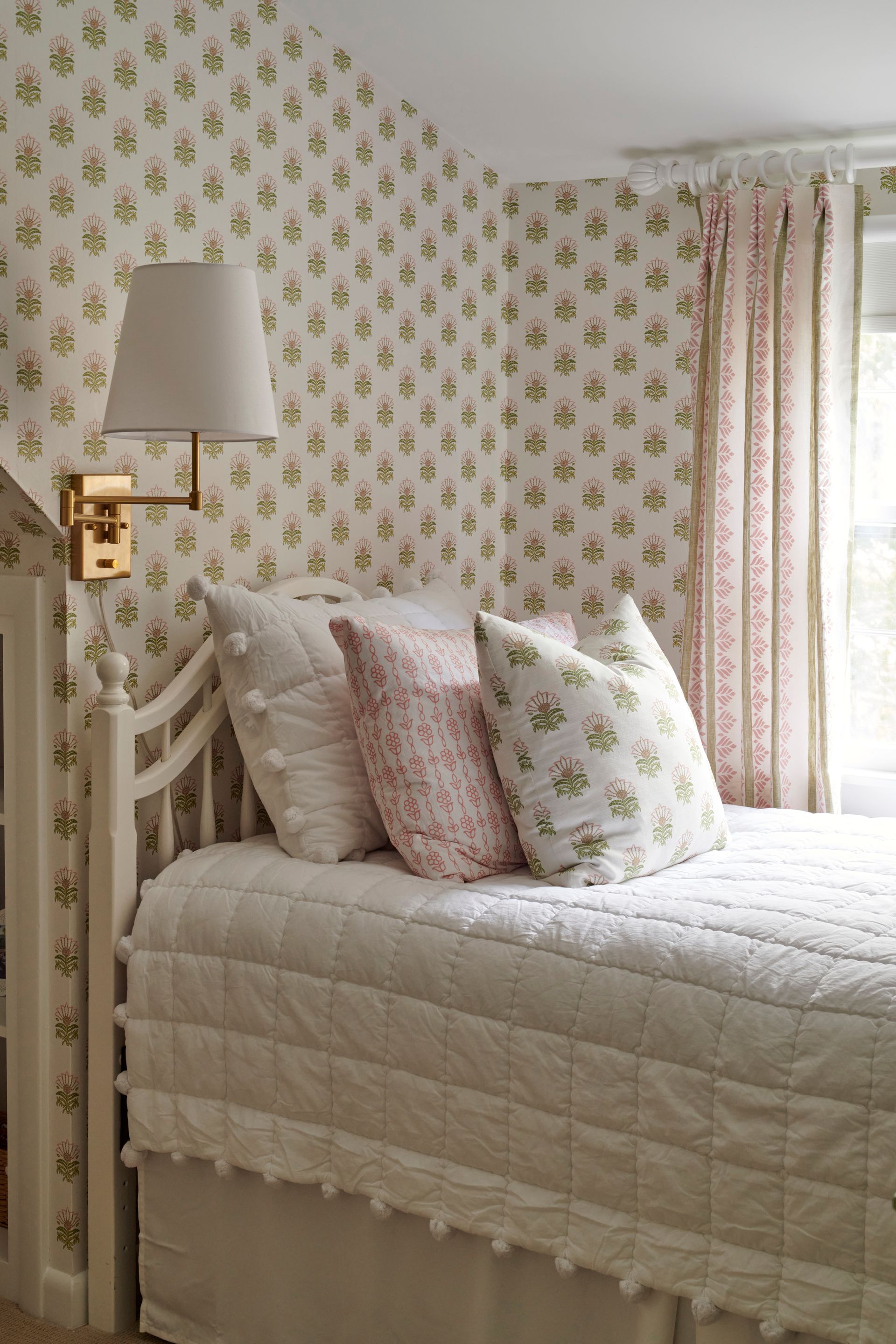 Bedroom with a bed, pillows, and a lamp