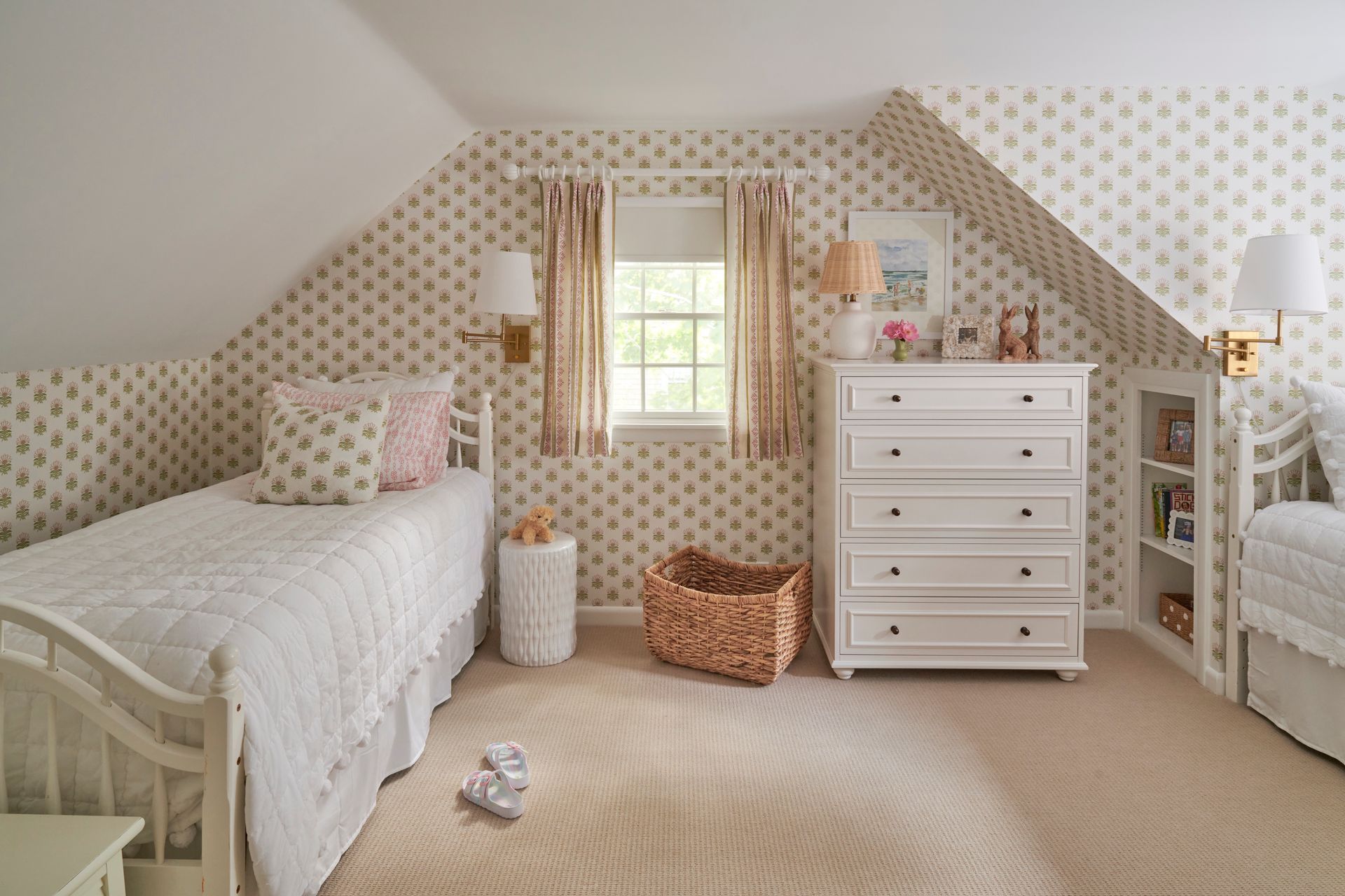 A bedroom with two beds, a dresser and a window