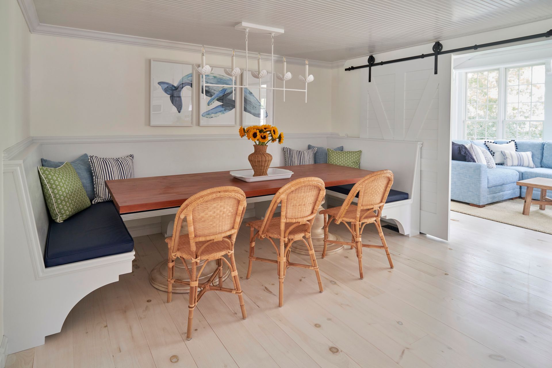 A dining room with a table and chairs and a bench