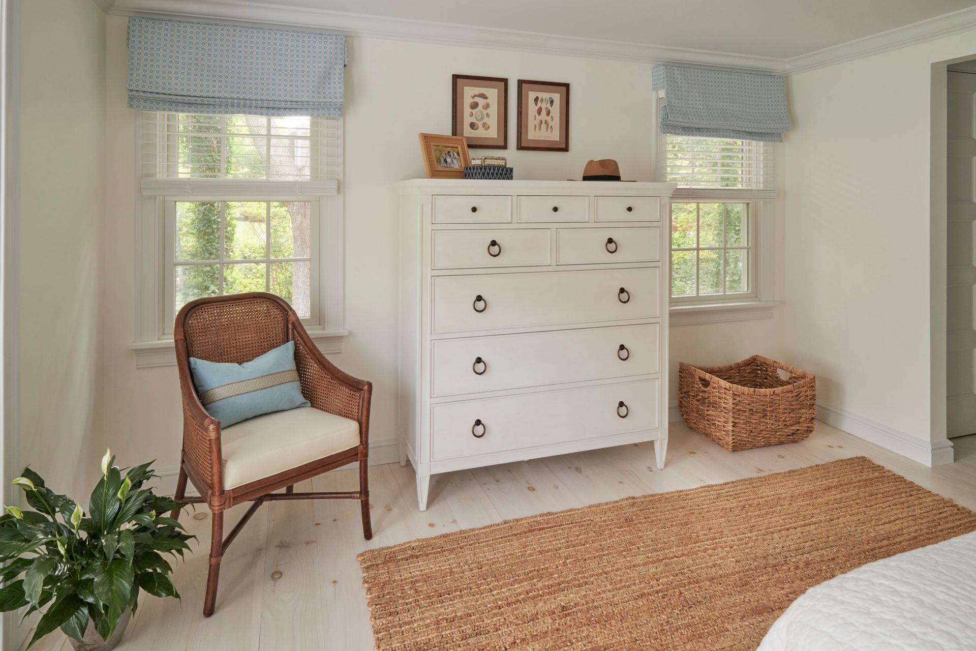 A bedroom with a dresser, chair, and rug