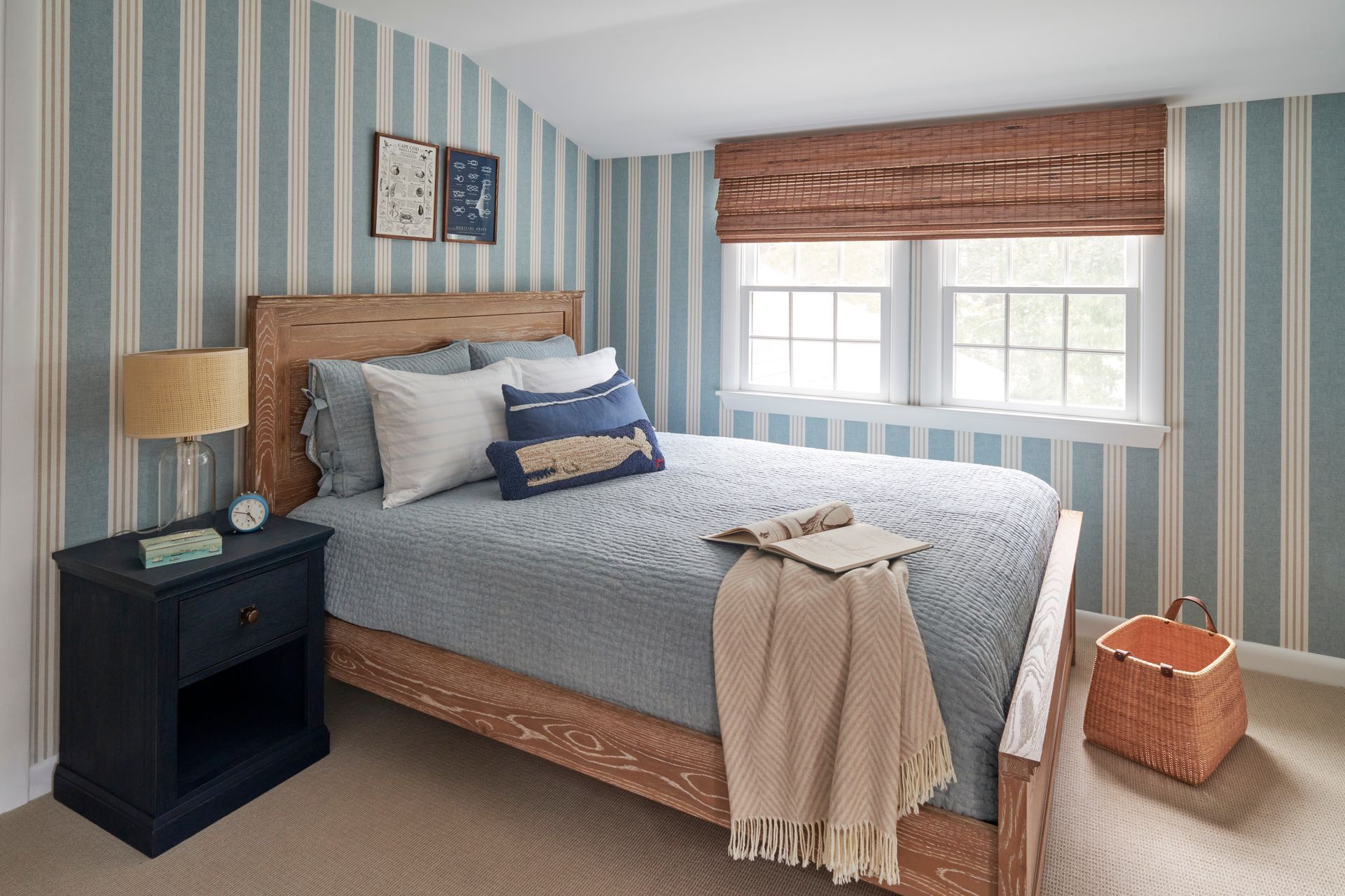 Bedroom with a bed, nightstand, lamp, and striped walls