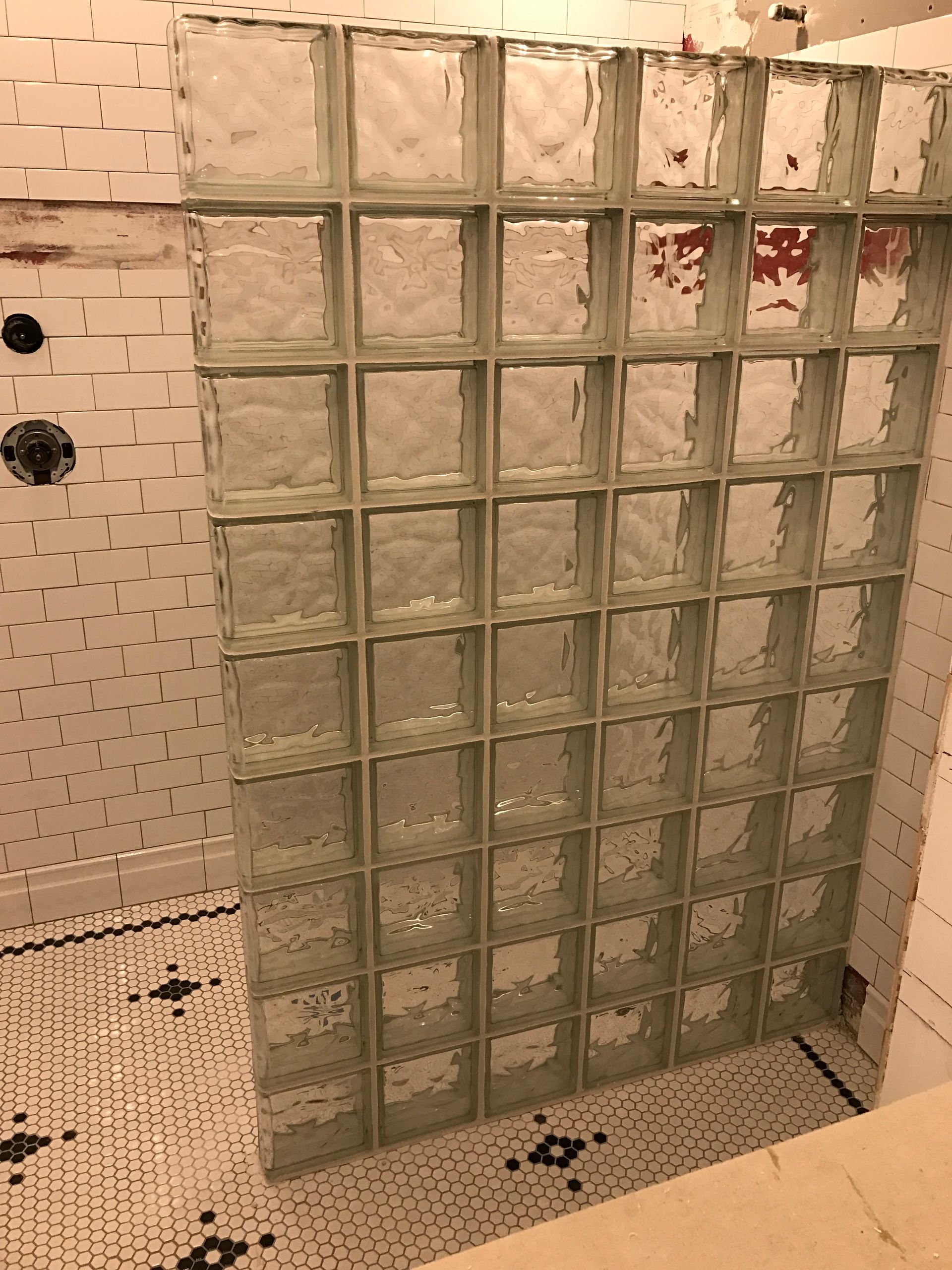 Glass block shower wall in a bathroom.