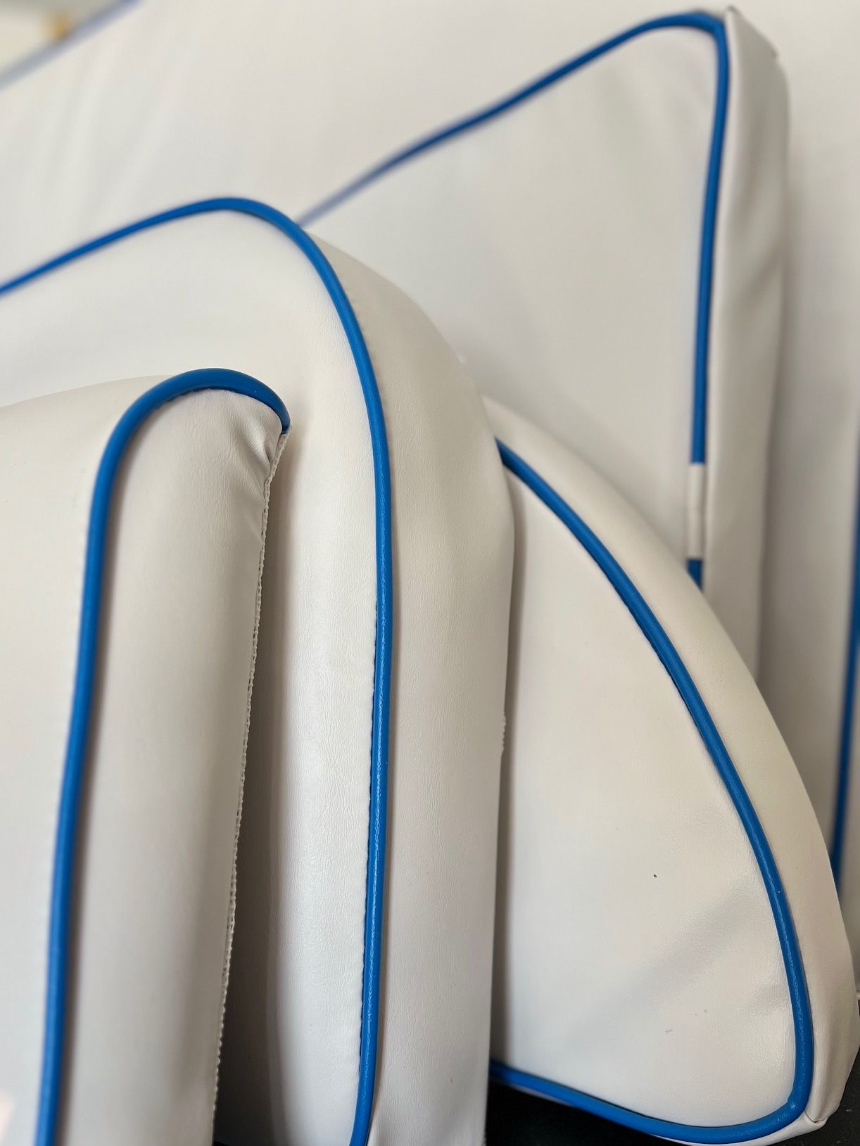 a white couch with blue trim