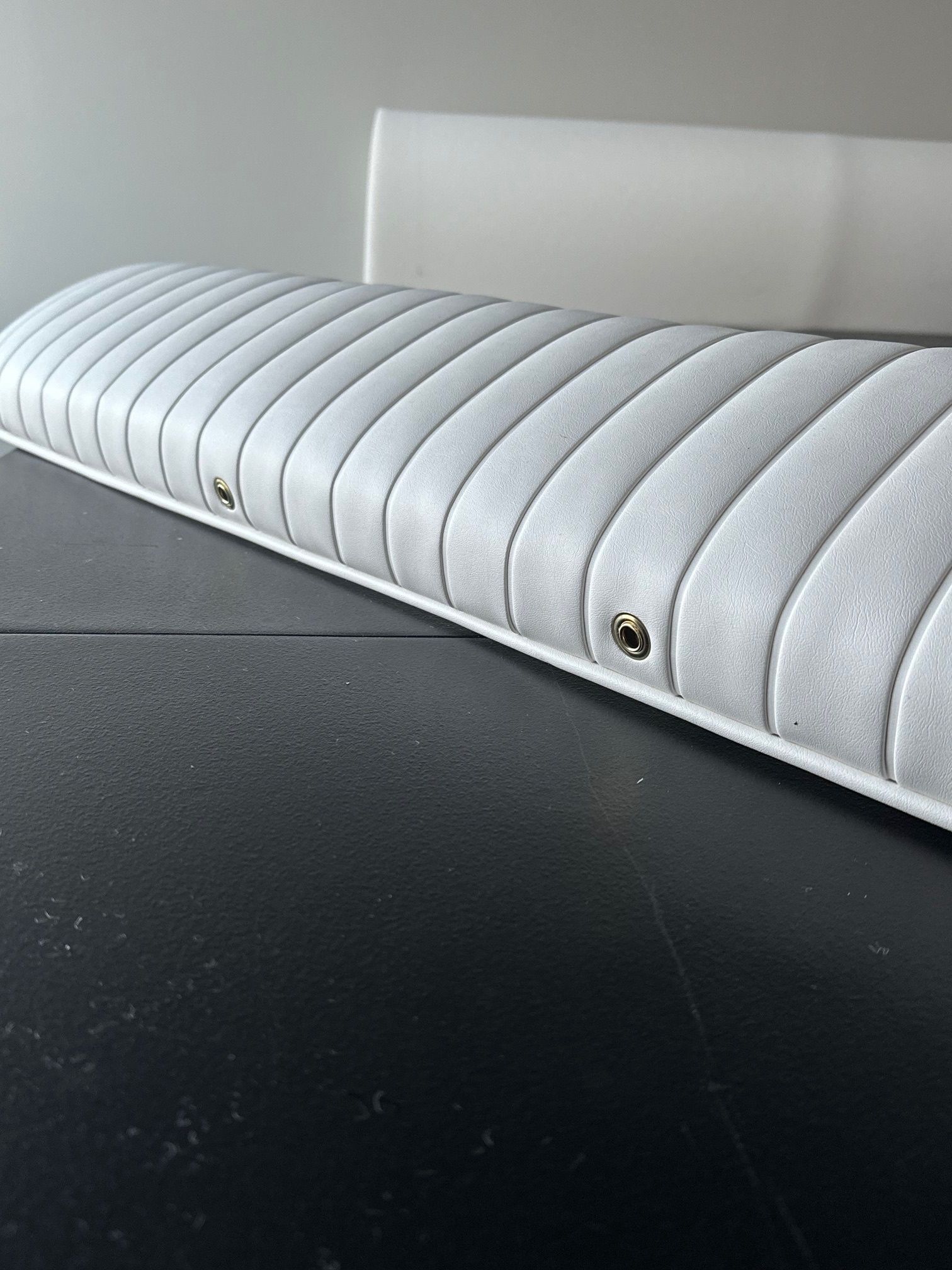 a white couch on a black floor