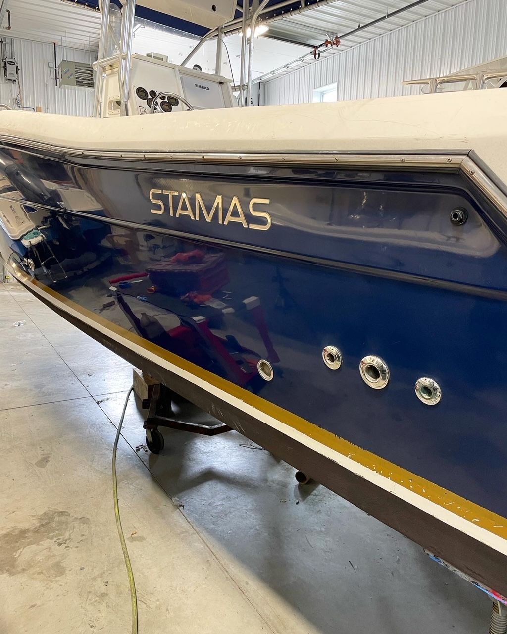 a blue boat with the name Stamas on the side
