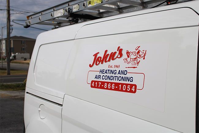 White service van with John’s Heating and Air Conditioning logo and phone number on the side.