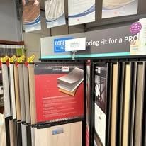 Store display of flooring samples, signs, and information panels with various colors and textures.