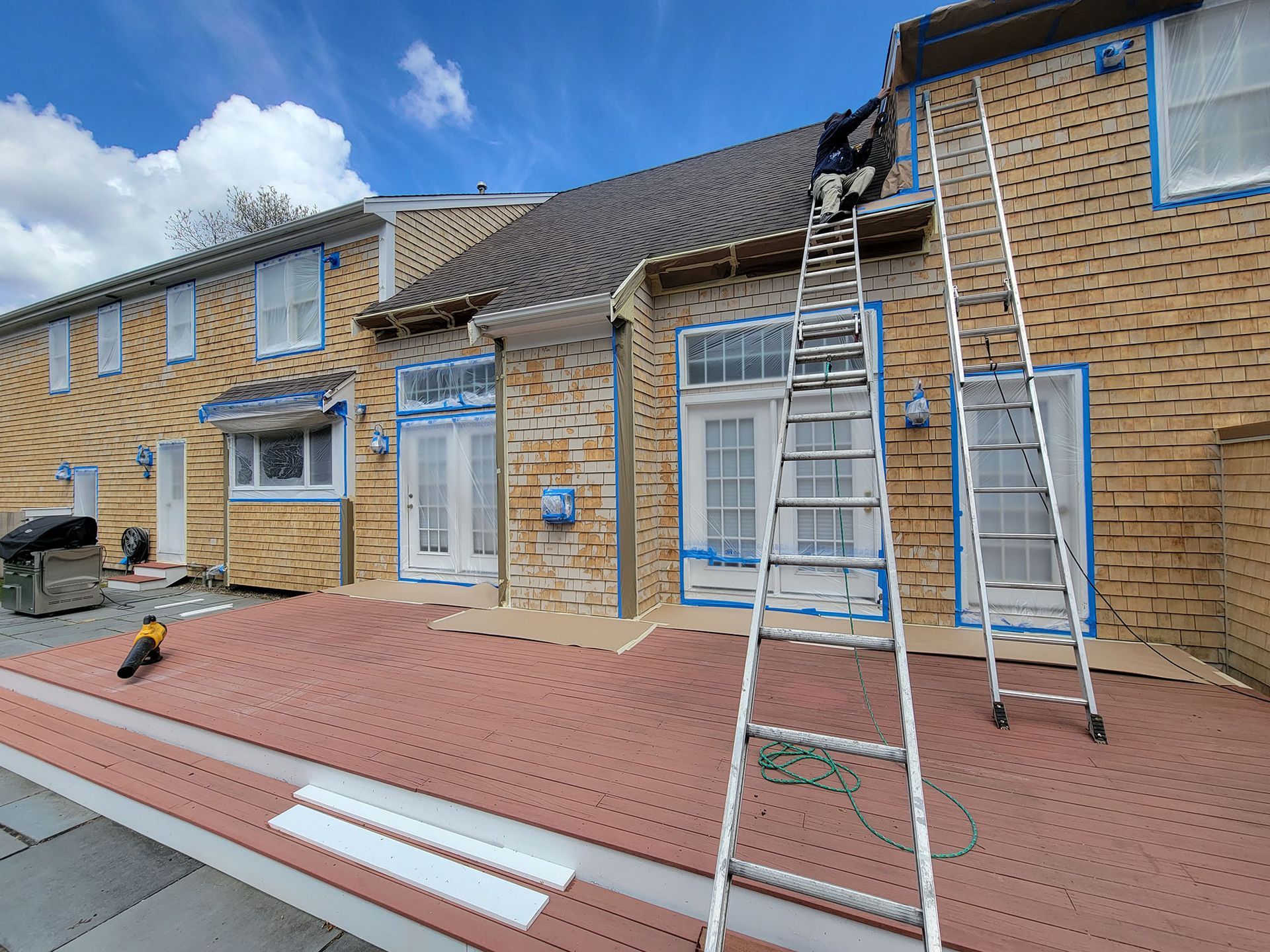 Brick row houses with ladders and scaffolding during exterior repairs