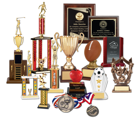 Assortment of trophies, plaques, and medals, including a football, soccer ball, and apple.