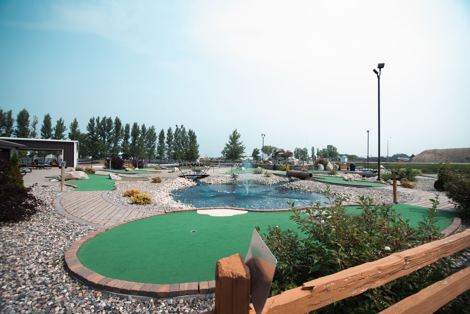 A golf course with a fountain in the middle of it