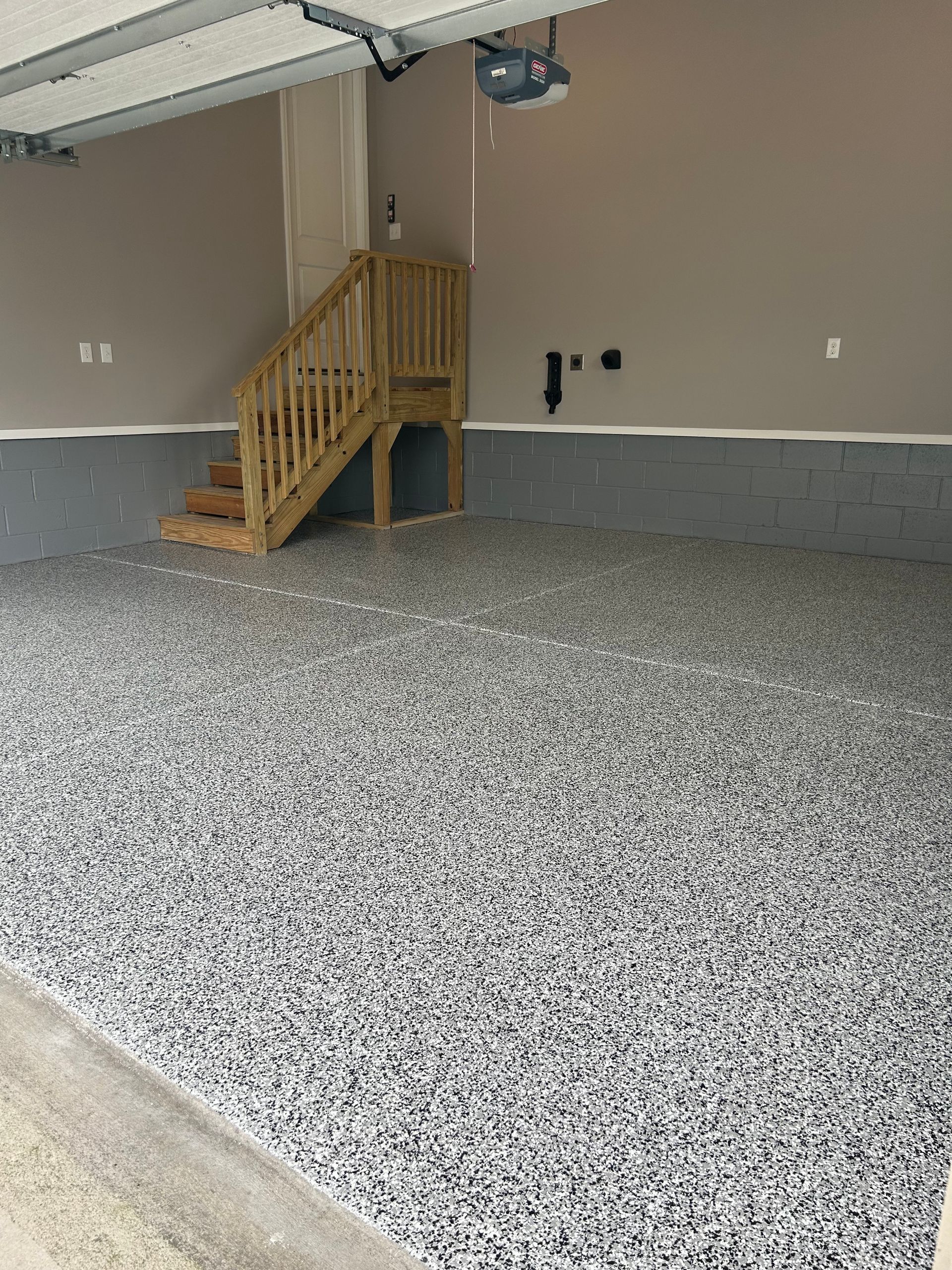 A garage with a deck and stairs in it.