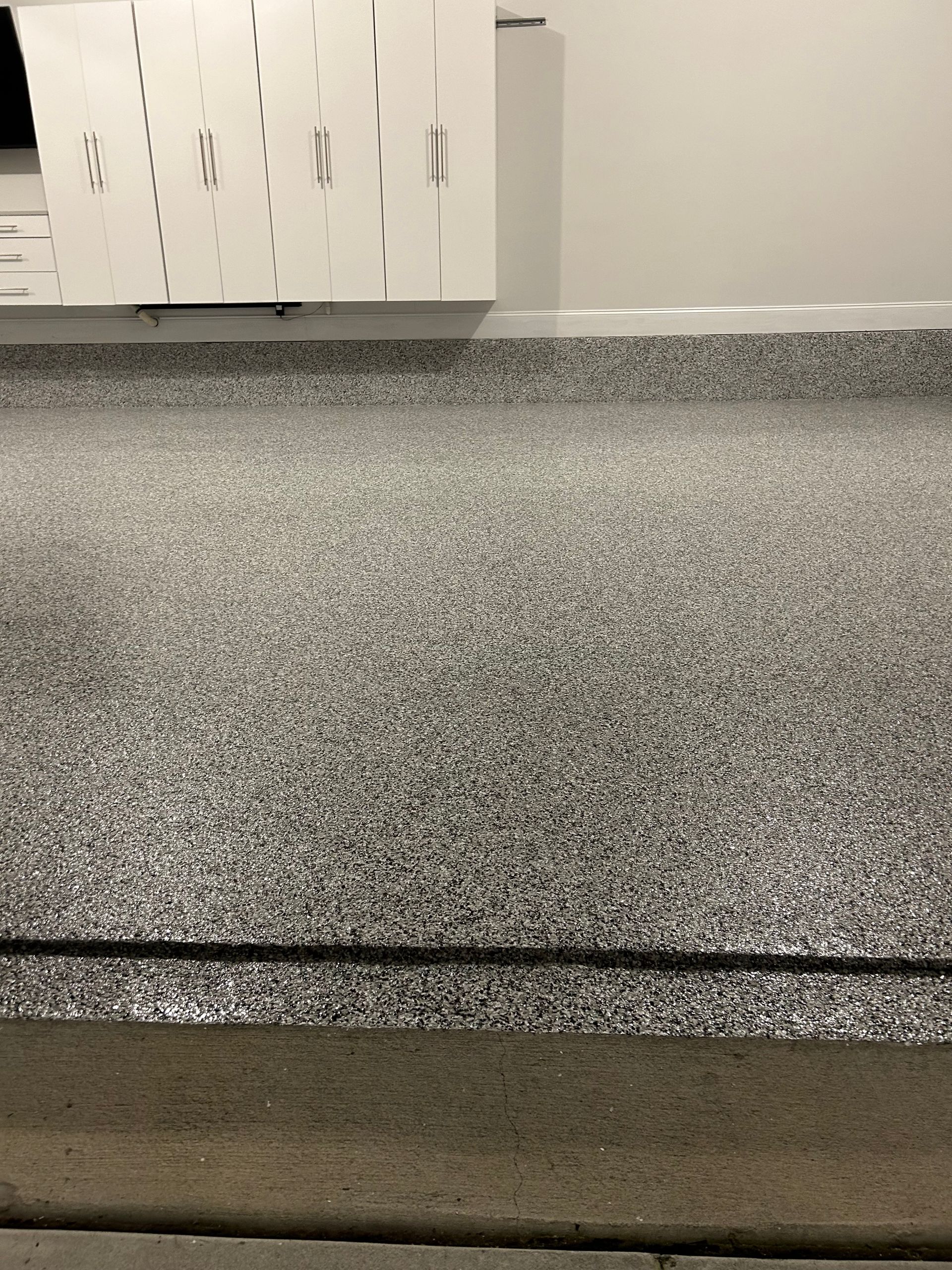 A garage floor with a lot of small stones on it.