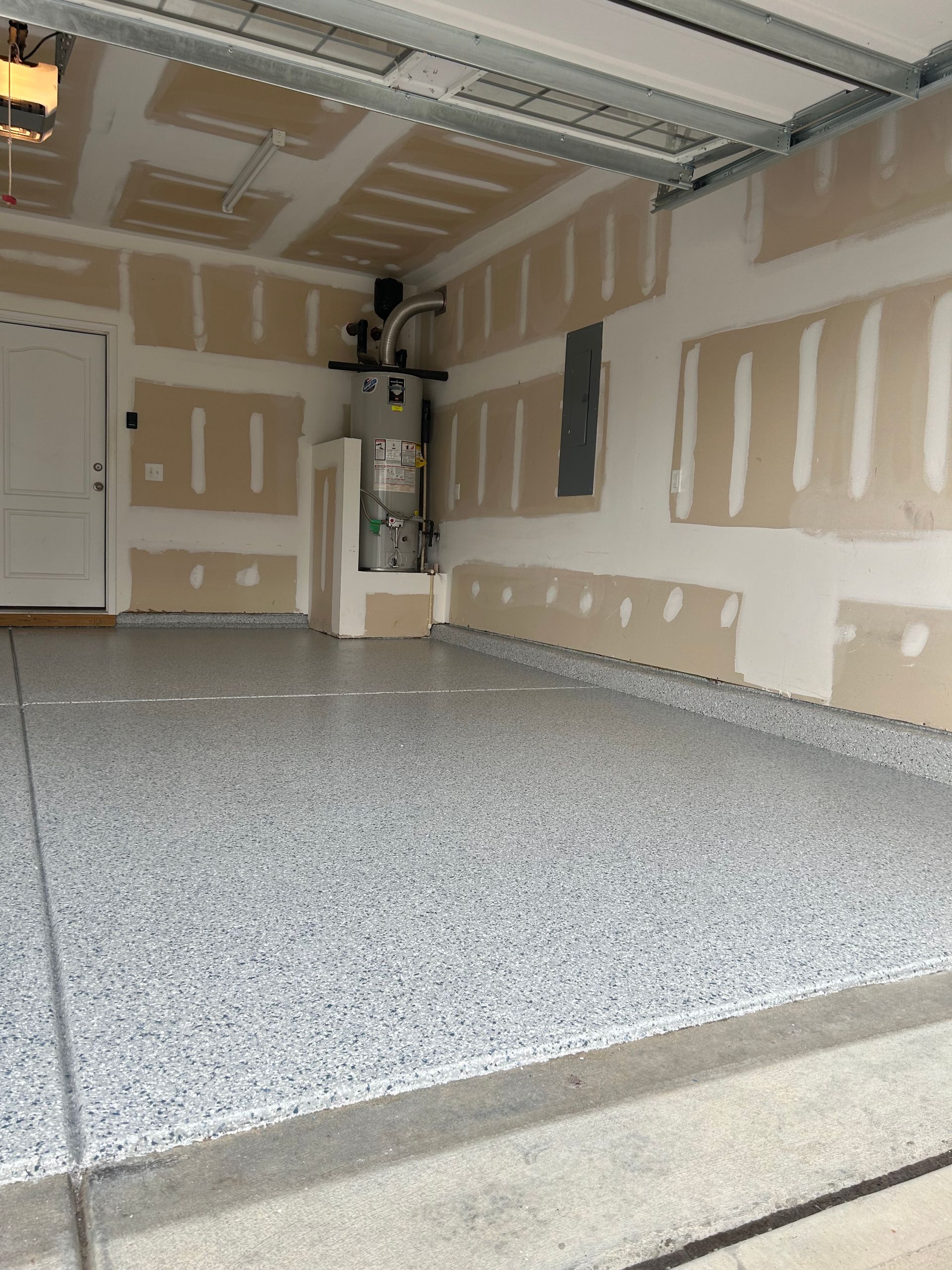 A garage with a gray floor and white walls
