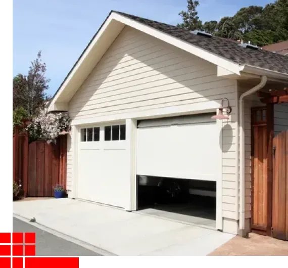 Two-car garage with white doors and beige siding beside a wooden fence