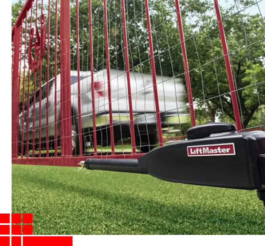 Red gate with LiftMaster opener in foreground and blurred white truck behind it