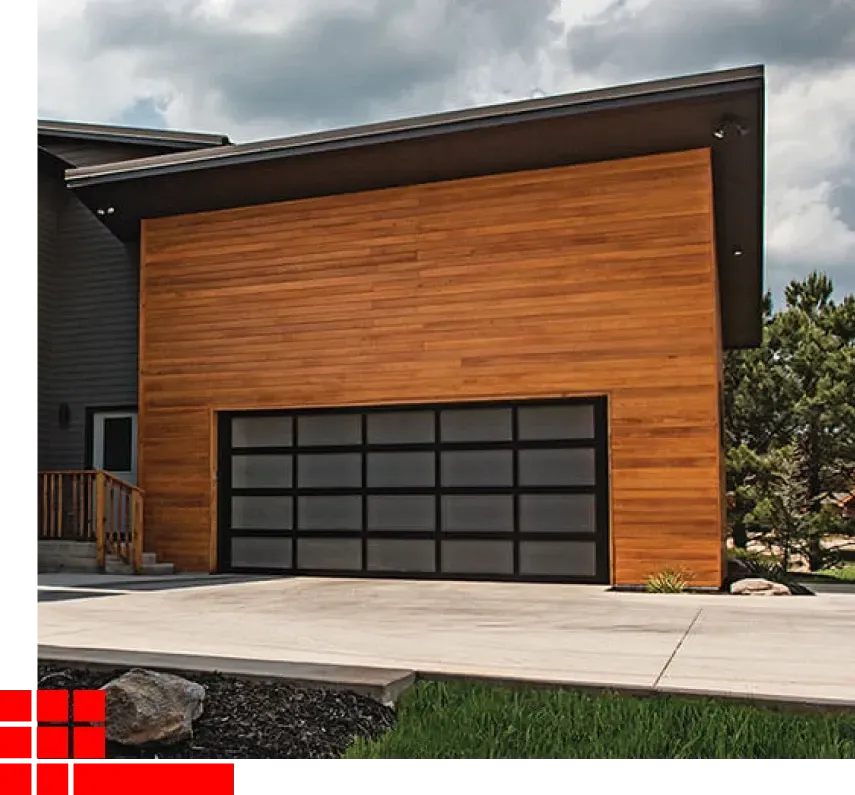 Modern house exterior with wood siding, a black garage door, and a sloped roof