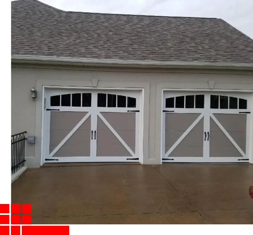 White garage with two matching double doors and a wet driveway under an overcast sky