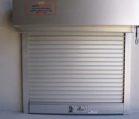 Closed silver metal roll-up shutter on a storefront