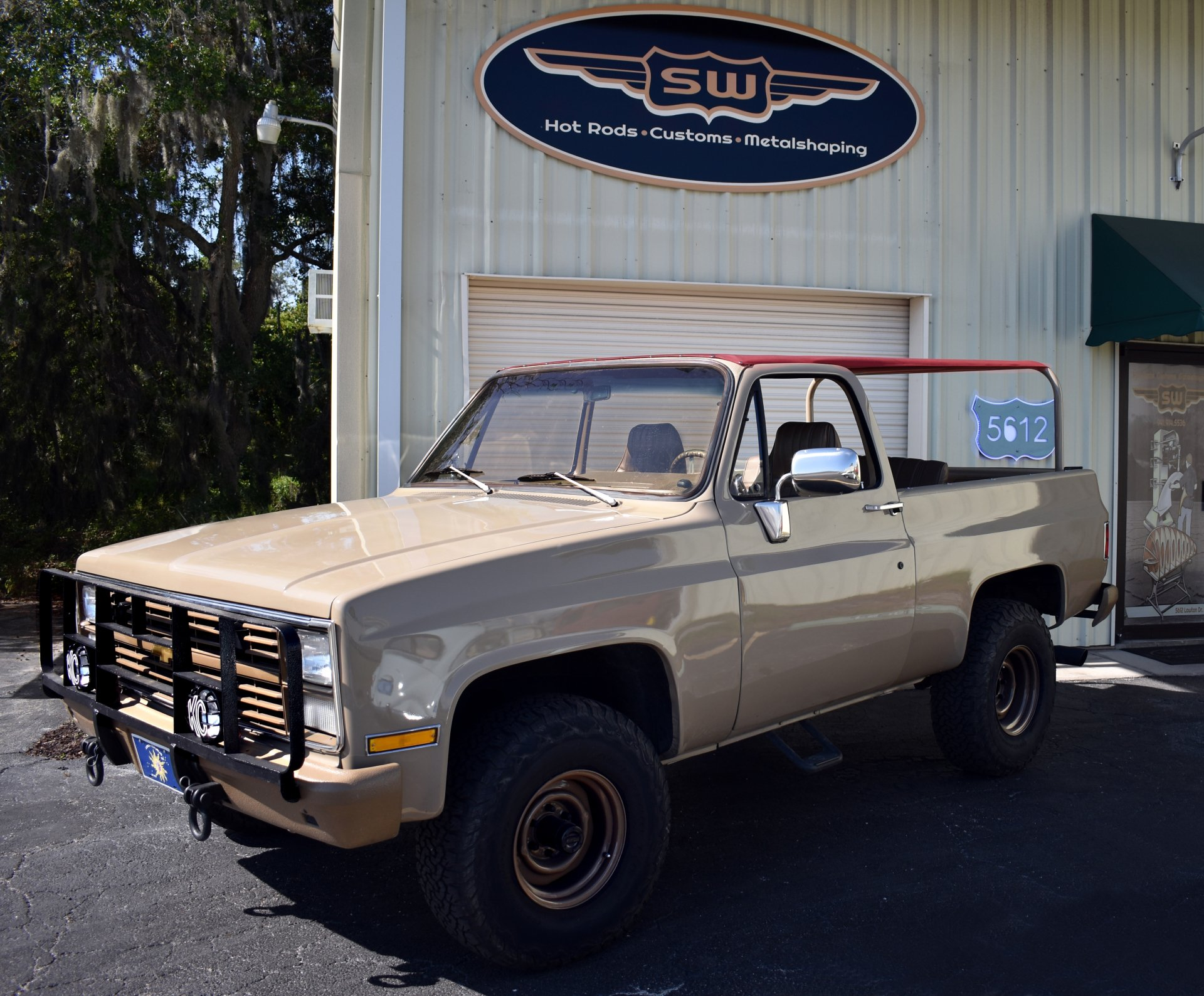 A truck is parked in front of a building that says sw