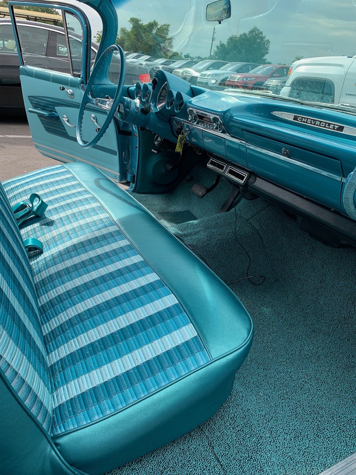 A blue car with a striped seat and a steering wheel