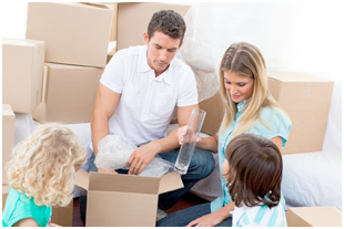Family packing items in boxes