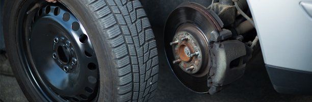 Car mechanic changing tire