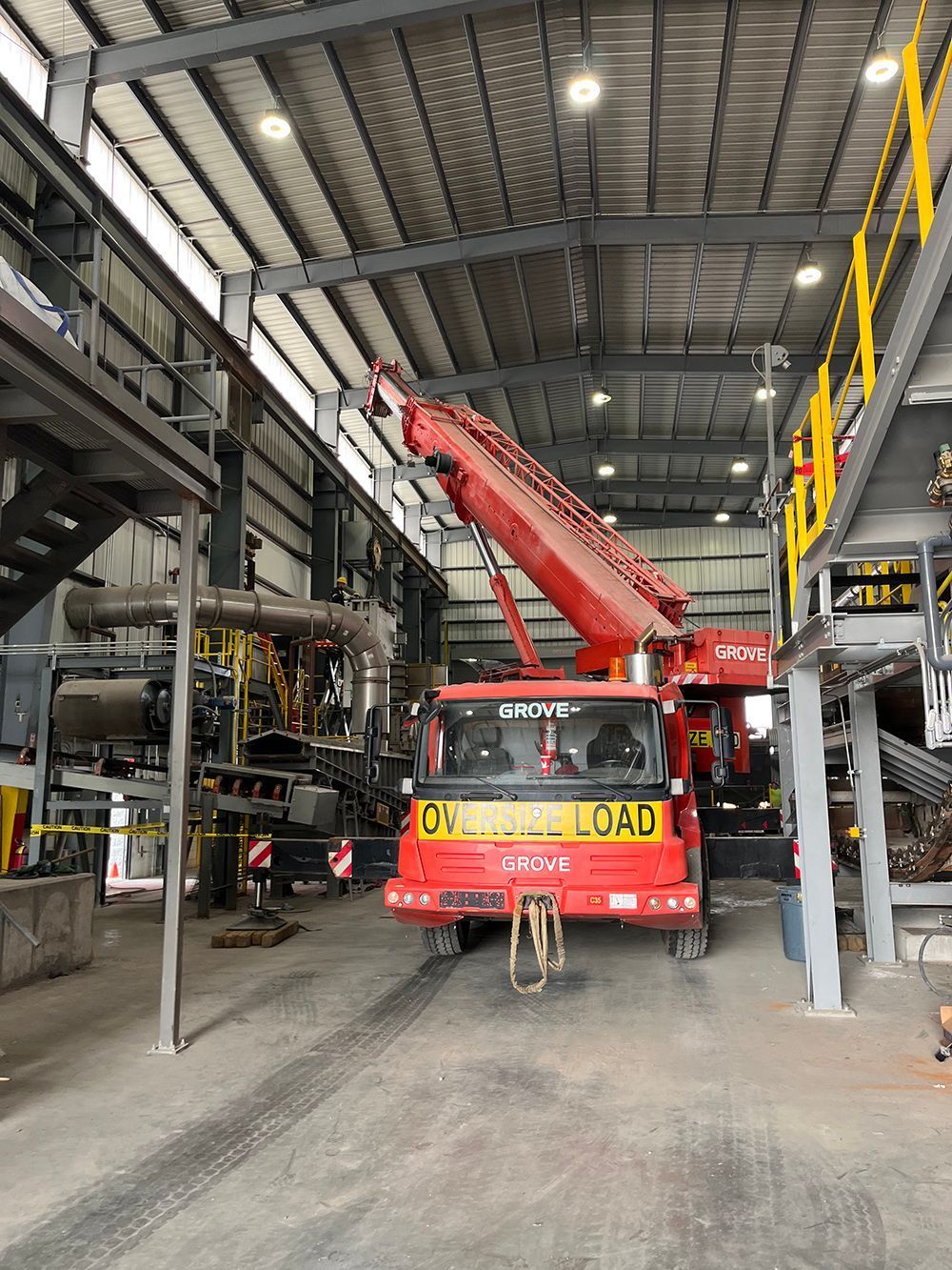 Red crane inside industrial building, labeled 