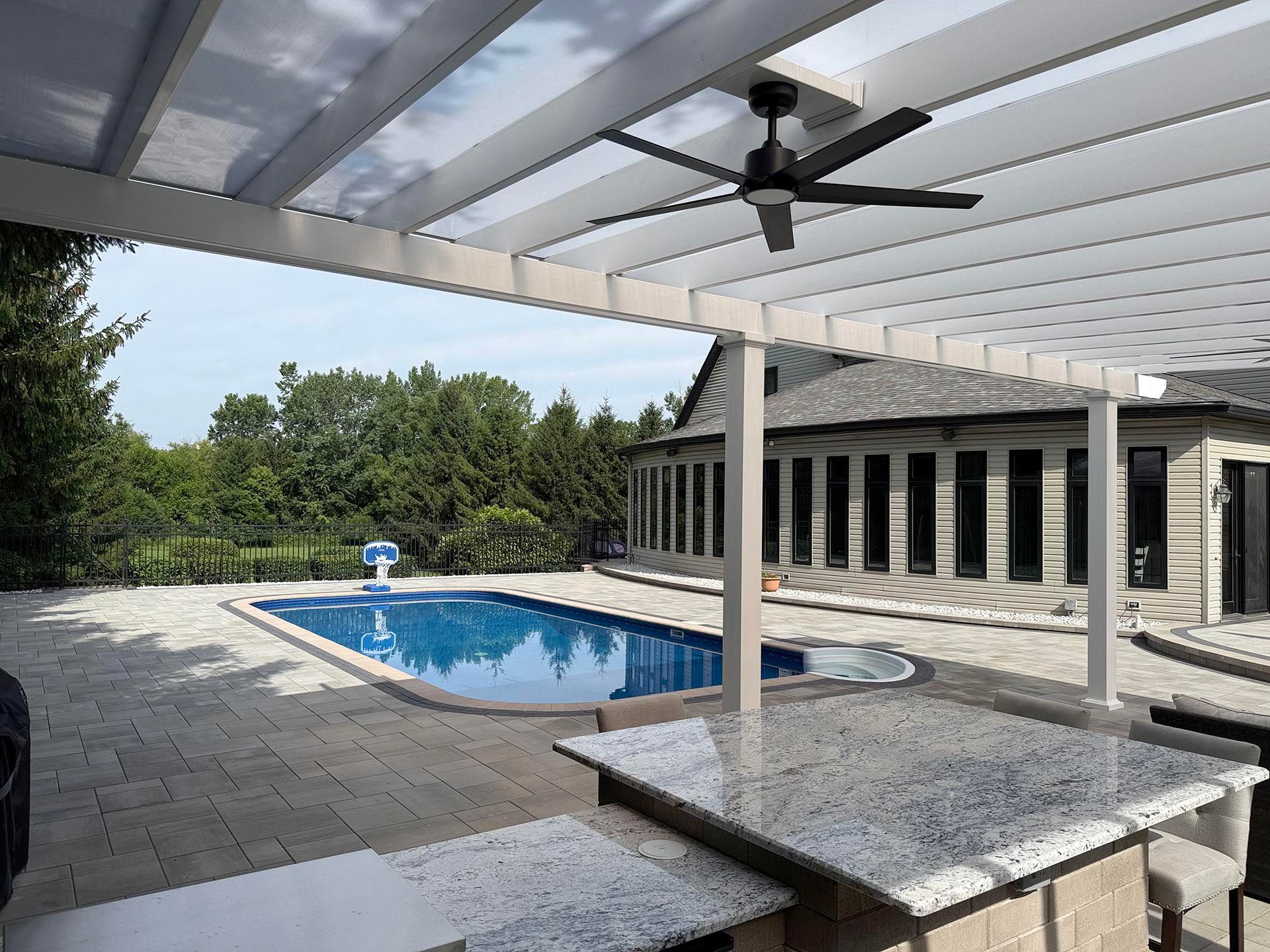 A granite outdoor bar under a white pergola