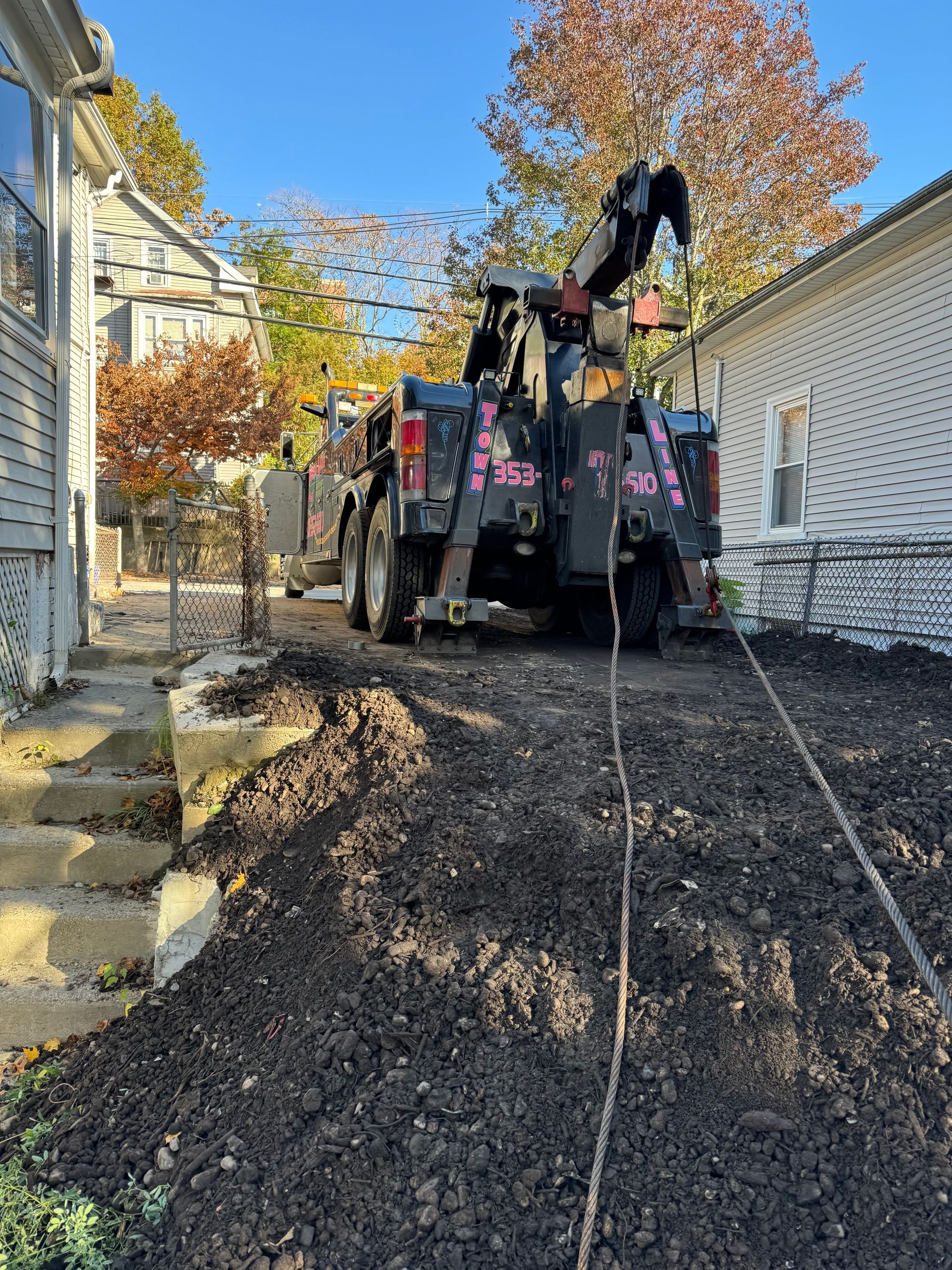 A tow truck is parked in front of a house.