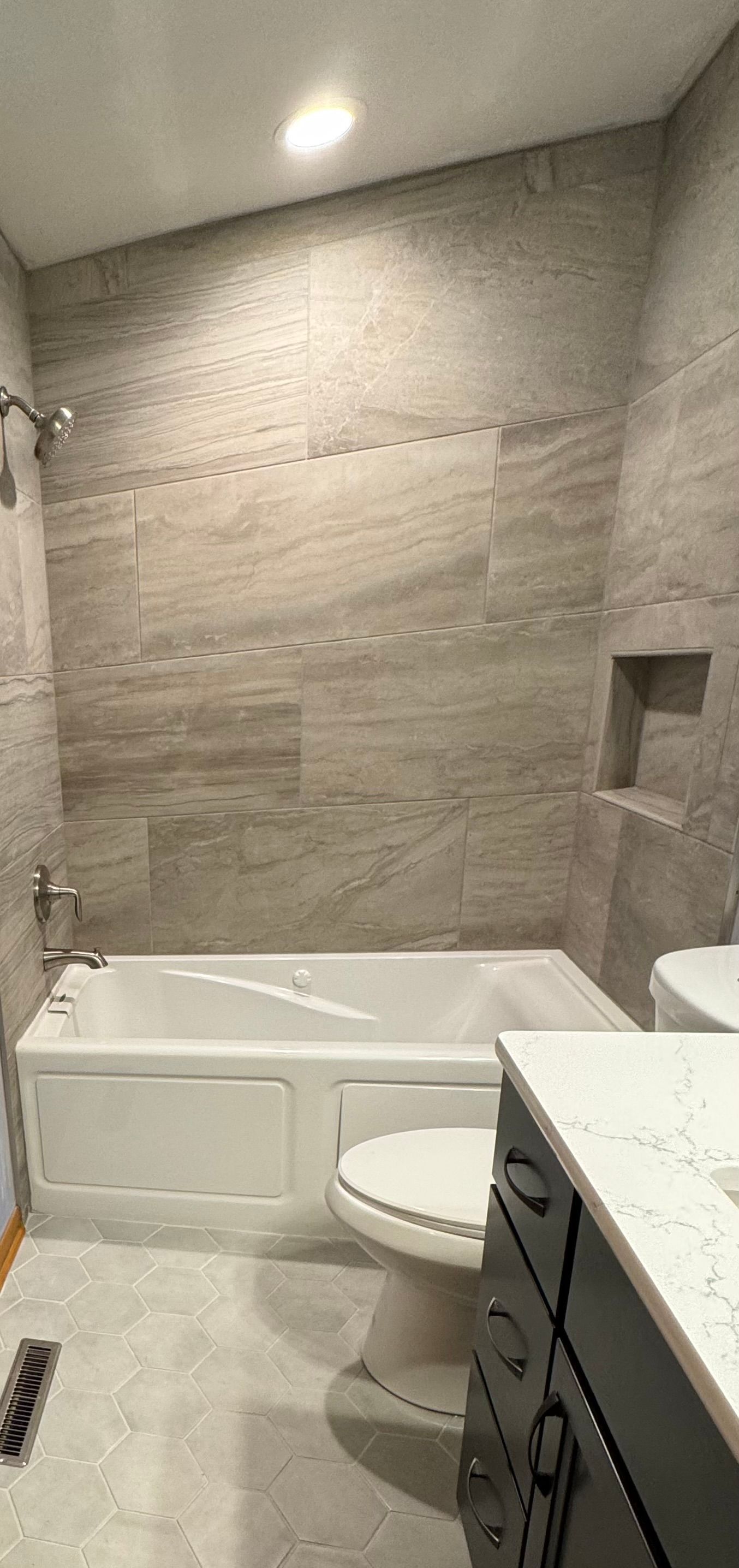 A bathroom with a tub, toilet, sink and shower