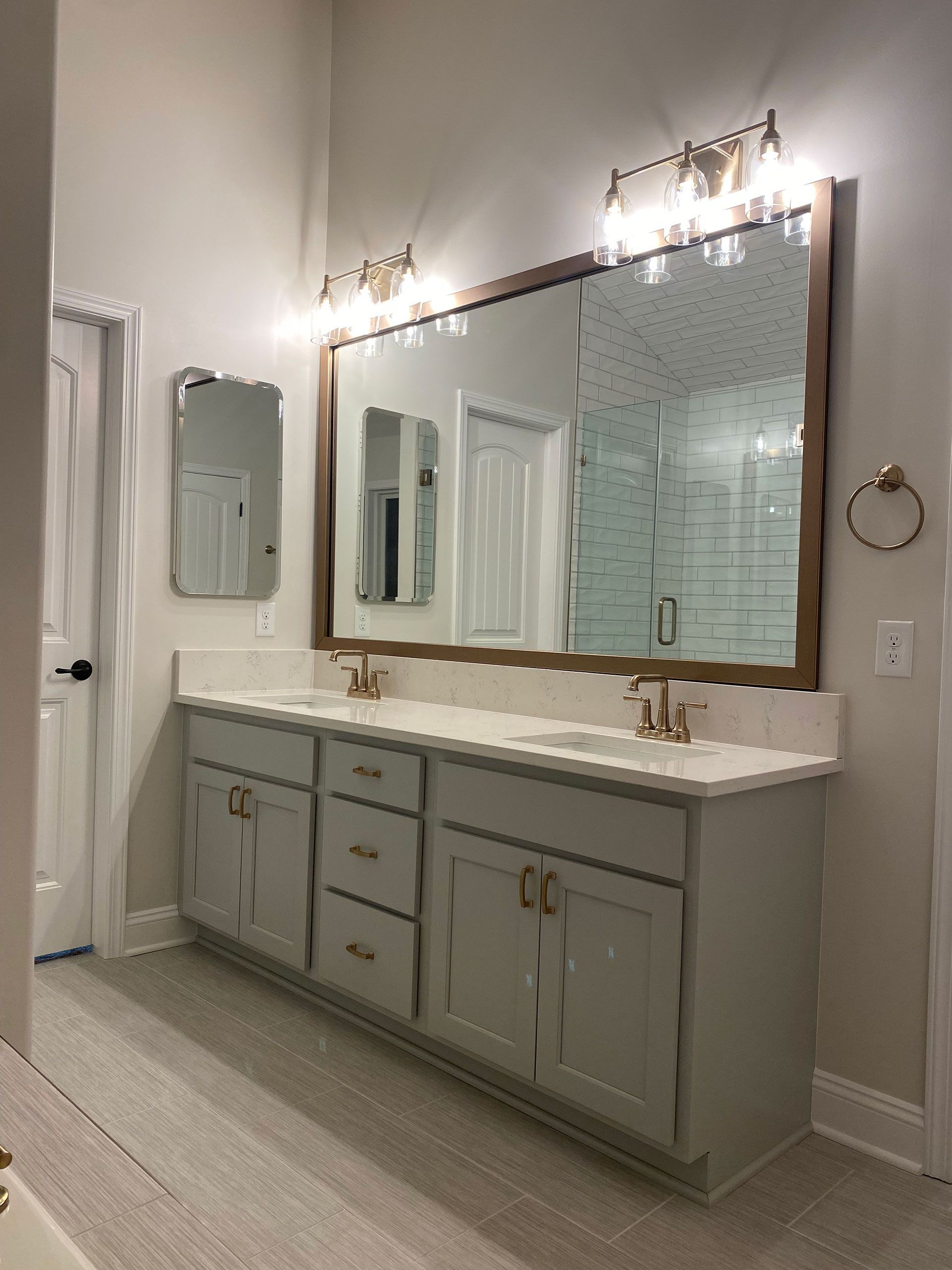 A bathroom with two sinks and two mirrors