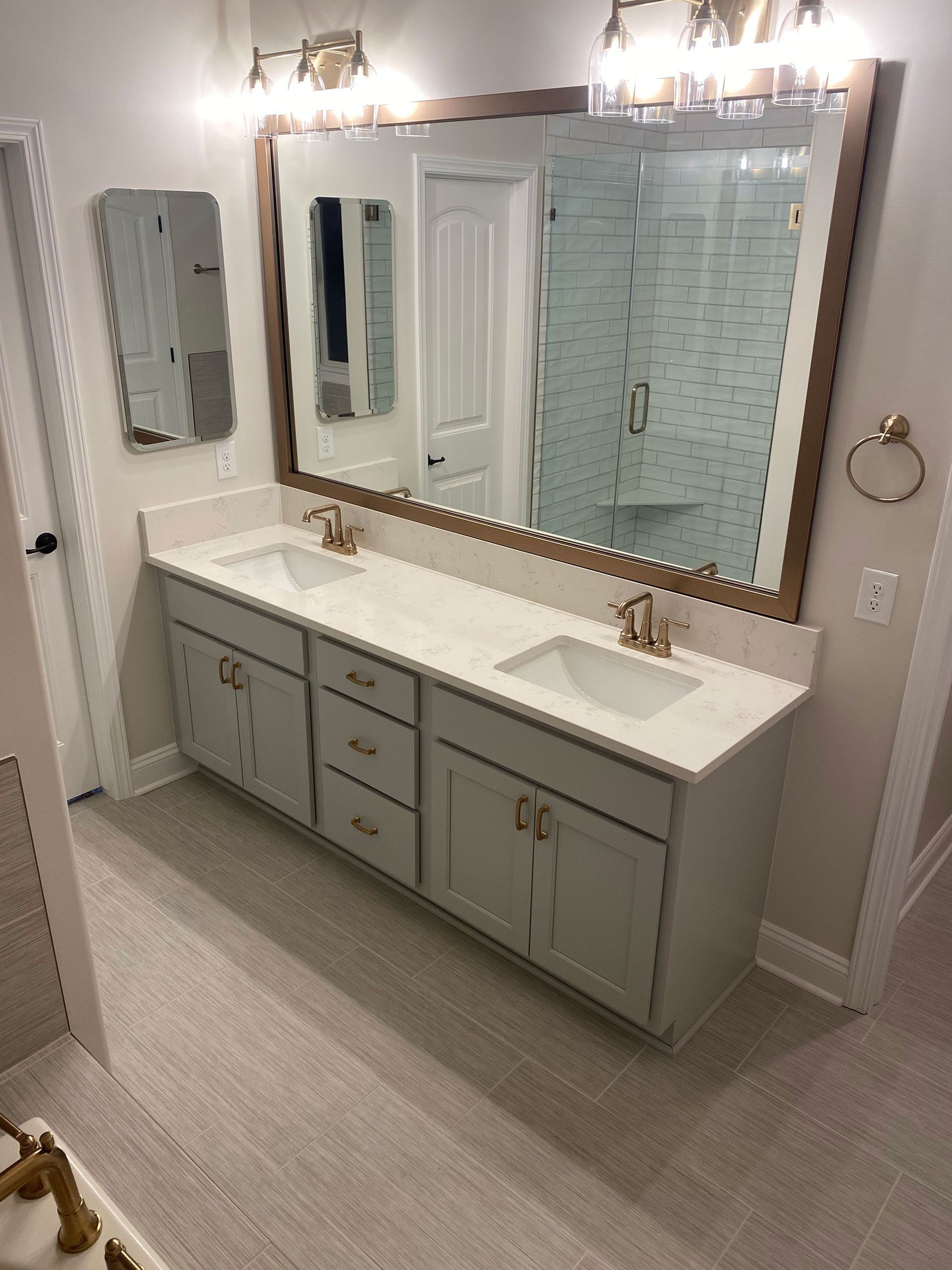 A bathroom with two sinks and a large mirror