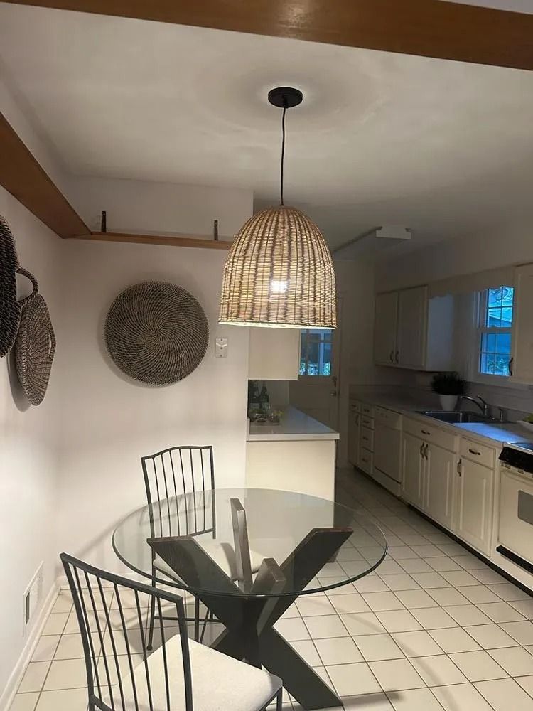 A man in a hard hat is installing a light fixture.