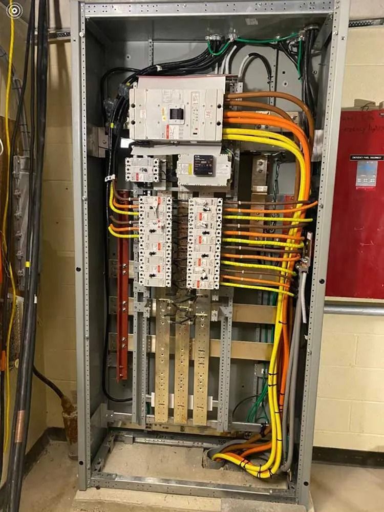 Two electric cars are being charged at a charging station.